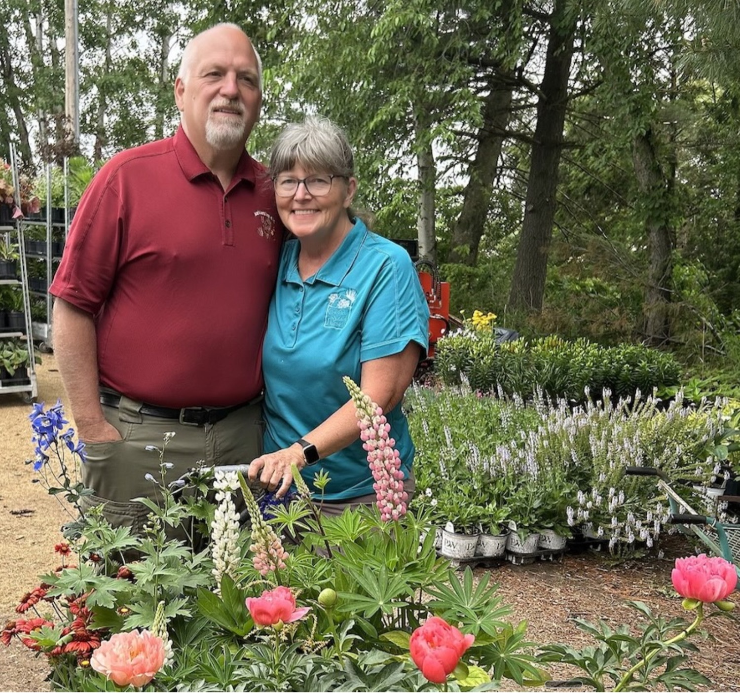 Darold and Janet Paisar standing among perennial plants at Glacial Stone Nursery.